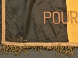 a black and yellow jacket with the word pour written on it