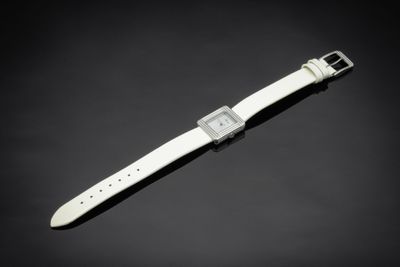 a close up of a watch on a black surface