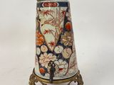 a small vase that is sitting on a stand