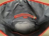 a red and black bag with a zipper on the inside of it