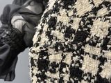 a black and white jacket and gloves on a mannequin mannequin mannequin mannequin mannequin mannequin mannequin
