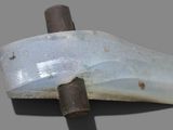 a close up of a knife on a gray surface