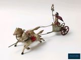 figurine of a man riding in a chariot pulled by a horse