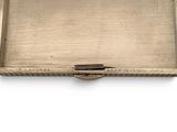 an old silver tray with a handle on a white surface
