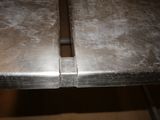 a close up of a metal table with a knife sticking out of it