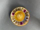 a yellow cup and saucer sitting on a table