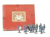 a group of figurines that are standing in front of a red box