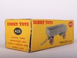 an old box of dinky toys sitting on top of a white surface