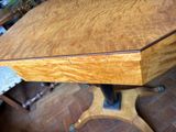a wooden table with a wooden top and a metal base