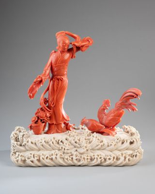 an image of a statue of a woman and a bird on a rock