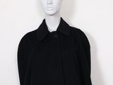 black wool coat with collar and buttons on a mannequin mannequin mannequin mannequin mannequin mannequin mannequin manne