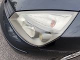 a close up of a car ' s headlight and front bumper