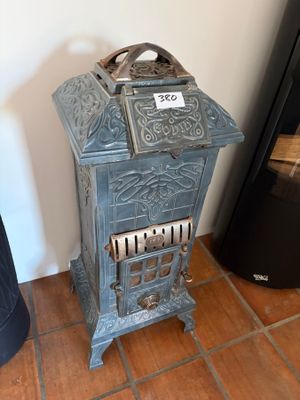 a small blue stove with a sign on the top of it