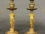 pair of antique brass candlesticks with figurines on bases