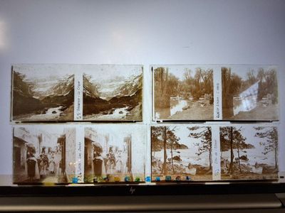 many old photos of people in the mountains on the wall