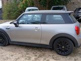 a silver mini cooper parked in a parking lot