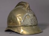 a gold fireman ' s helmet on display on a table