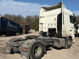 a truck that is parked in a lot with other trucks in the background