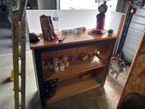 a wooden shelf with various items on it in a garage