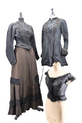 two dresses on a mannequin stand and a dress on a mannequin stand