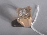 a gold ring with a diamond on top of it