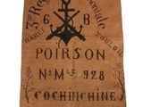 une vieille serviette marron sur laquelle sont représentés une ancre et une croix noires