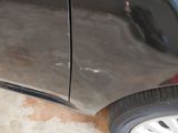 a close up of a car ' s side door and tire