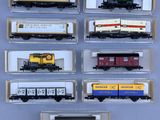 several model train cars are lined up in a display case