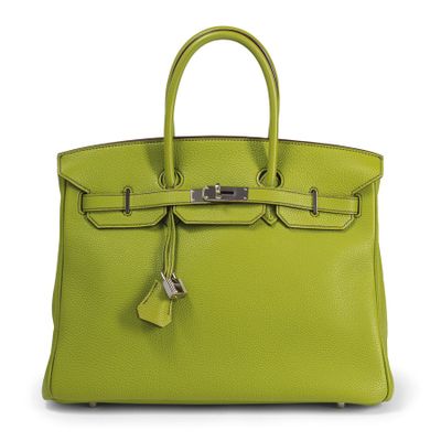 a lime green leather handbag with a lock on the handle
