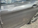 a car that has been dented and is parked on the side of the road