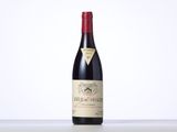 a bottle of red wine sitting on top of a table