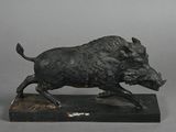 statue of a boar running on a marble base on a gray background