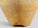 a large vase with a brown base on a gray surface