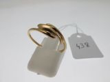 an image of a gold ring sitting on top of a white table