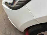a close up of a white car with a red tire