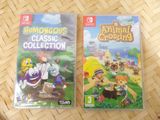 two nintendo wii games sitting on top of a wooden table