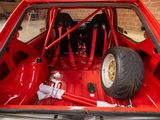 a red car with two tires in the back of it