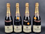 three bottles of champagne sitting next to each other on a table