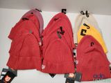 several hats are hanging on a wall with tags on them