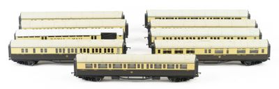four model trains are lined up in a row on a white surface