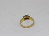 a close up of a gold ring with a black diamond on it