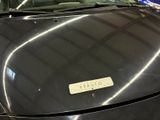 a black car that has a sticker on the hood of it