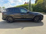 the bmw x5 is parked in a parking lot