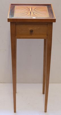 a small wooden table with a tile top on it