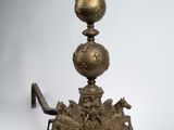 an antique brass candle holder with a bird on top of it