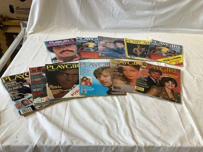 a lot of magazines on a bed with a white sheet