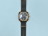 an image of a watch on a blue surface with a white background