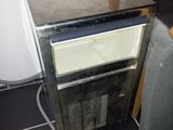 an image of a small refrigerator in the corner of a room