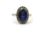 a close up of a ring with a blue stone in it