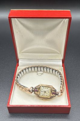 an image of a lady ' s wrist watch in a red box